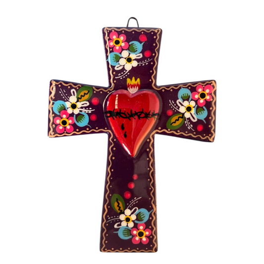 Decorative cross with colorful floral patterns and a red heart on a white background