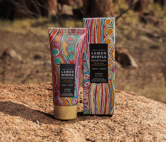 lemon myrtle hand cream and box on a sandstone ledge with a rustic bakground.