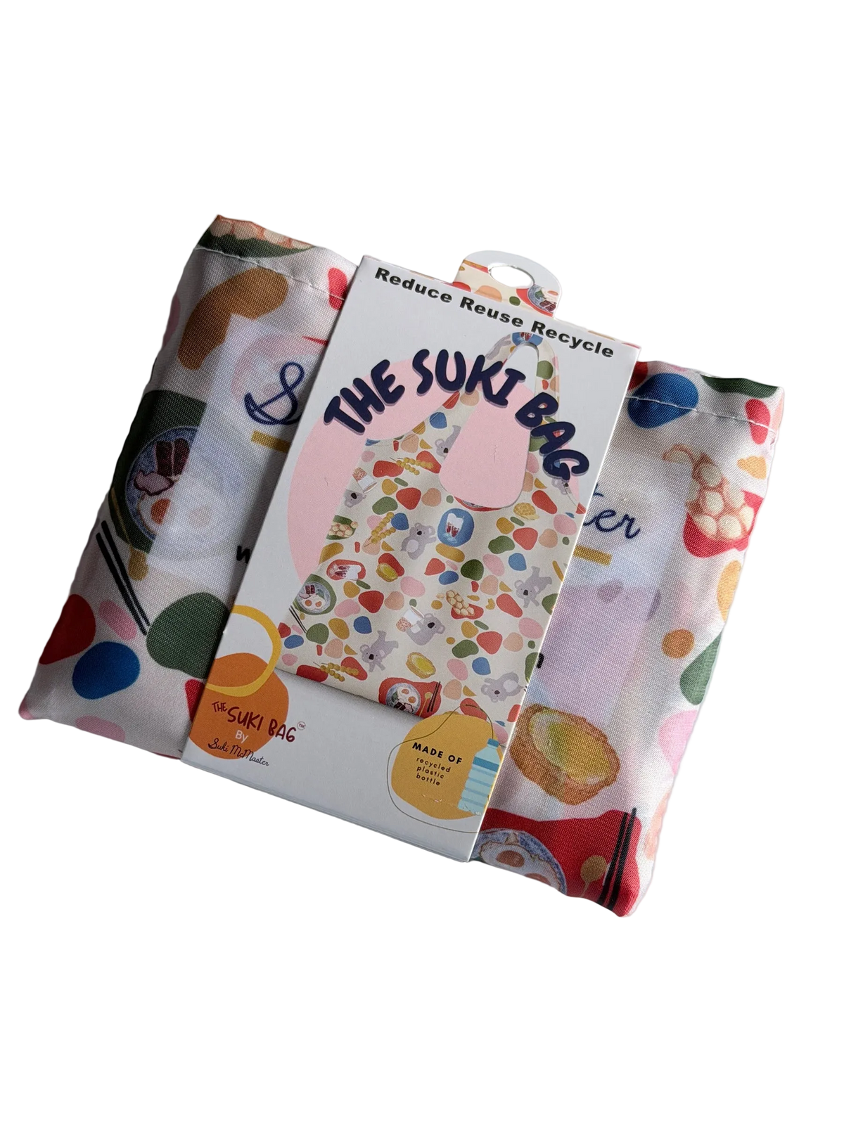 A folded shopping bag with a paper band, the text reads: The Suki Bag