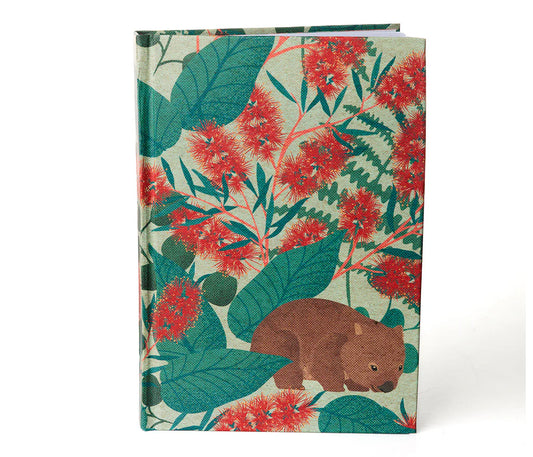 Notebook with a wombat and floral design on a white background
