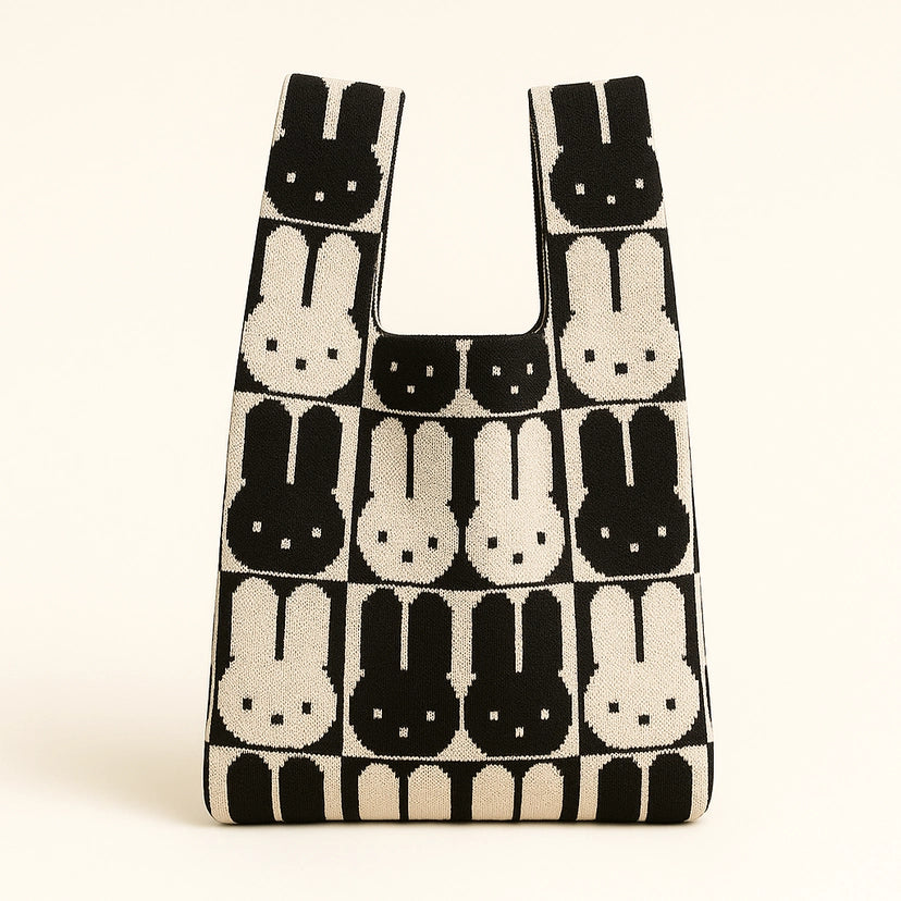 Reusable shopping bag with black and white rabbit pattern on a beige background
