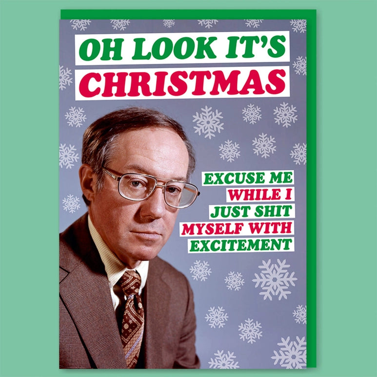A blue greeting card with snowflake print, a man in a brown suit and spectacles . Text above and bellow on a green background