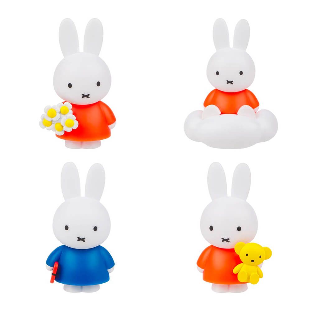 Set of four rabbit figurines in different poses and outfits on a white background