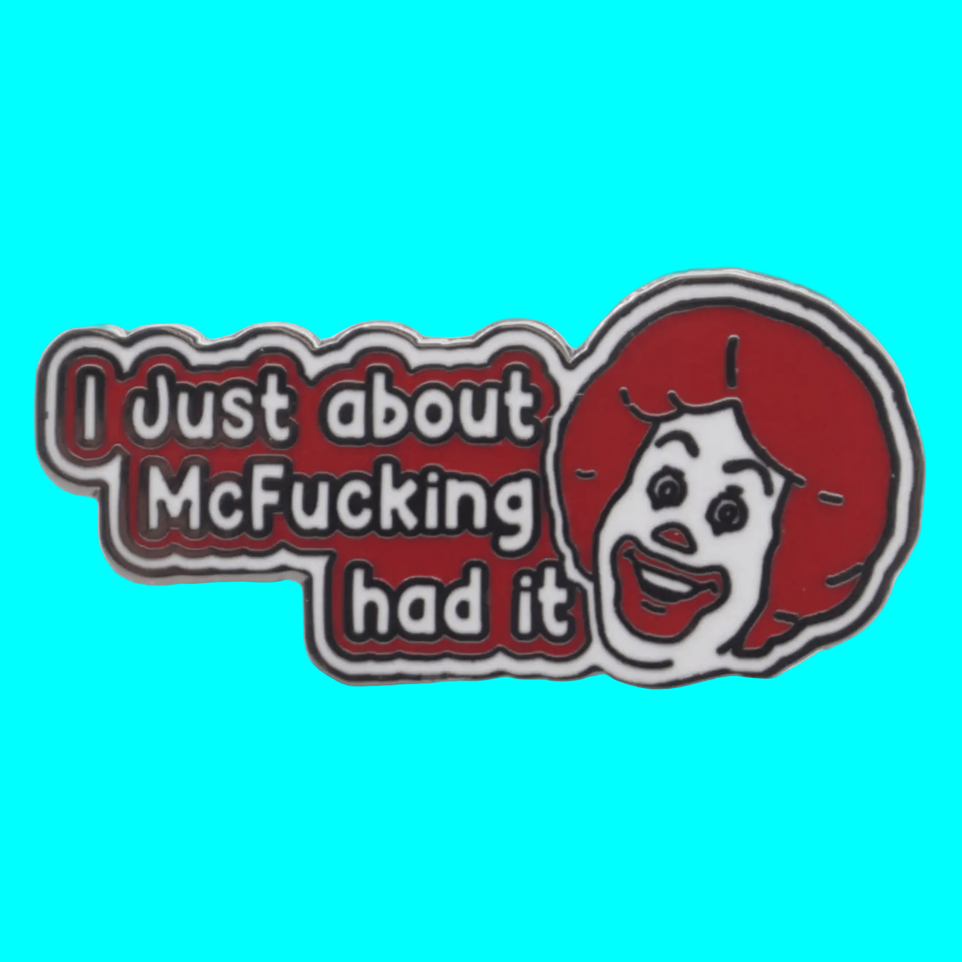 Metallic badge with a cartoon character and text on a blue background