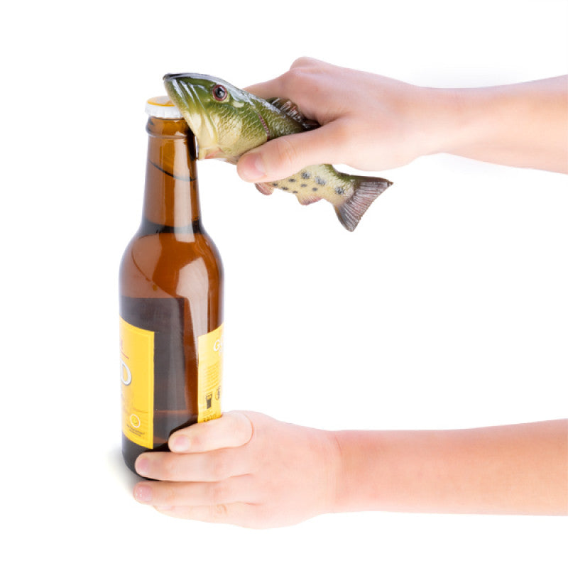 Fish-shaped bottle opener being used to open a beer bottle.