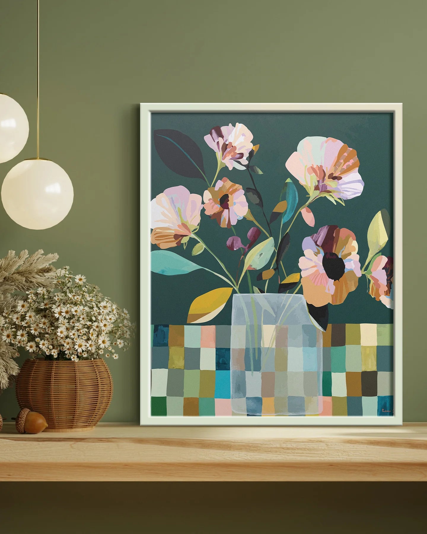 Framed floral artwork on a wall with a green background