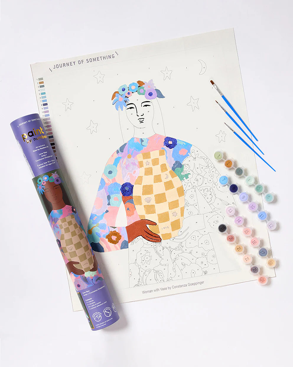 Coloring process with a colorful illustration of a person and art supplies on a white background