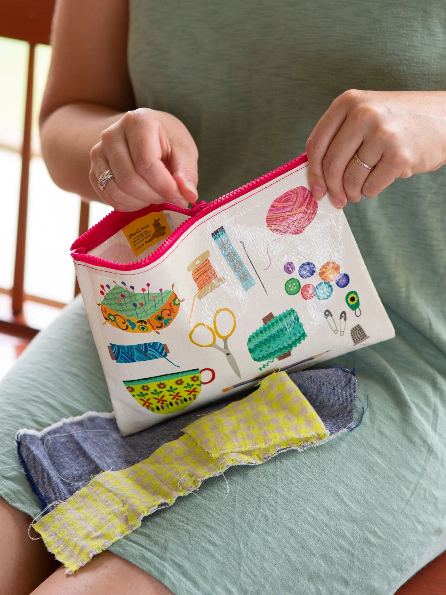 The women is zippering her pouch.