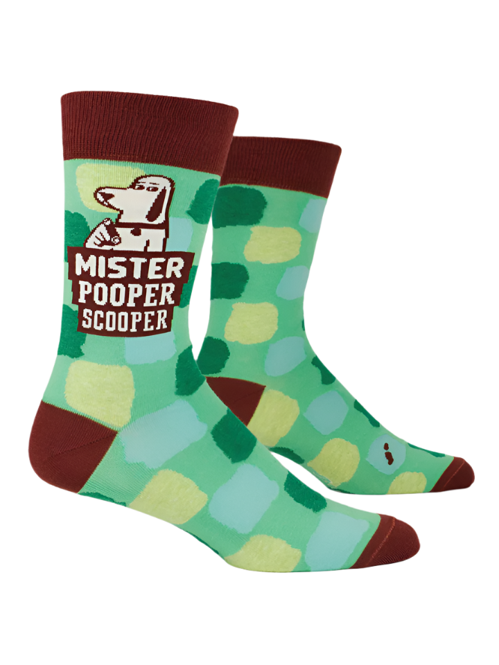 Blue Q Mister Pooper Scooper men's crew socks. Green socks with a brown band on heel, toe . Features a cartoon of a dog pointing to the camera.