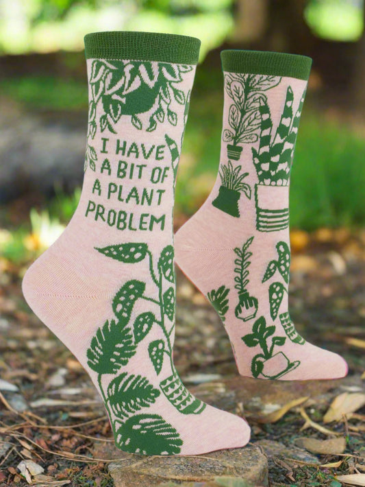Pair of socks with plant-themed design and text on a white background