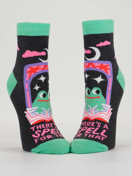 Pair of socks with a witch design and text on a white background