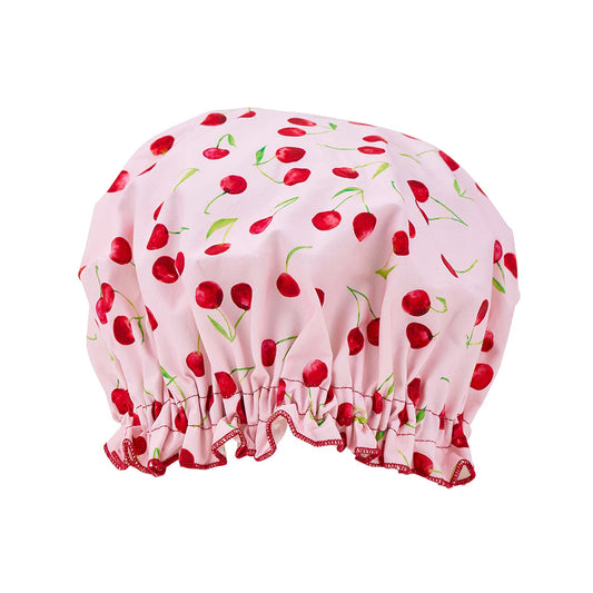 Pink shower cap with cherry pattern on a white background