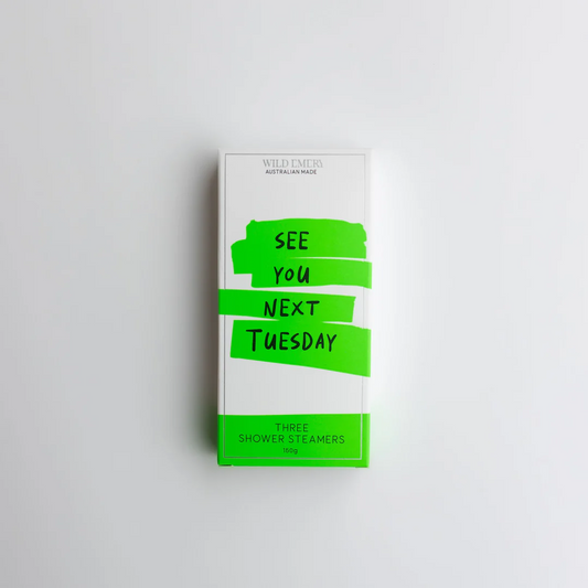A green box containing a trio of Wild Emery shower steamers. The caption reads: See you next Tuesday.