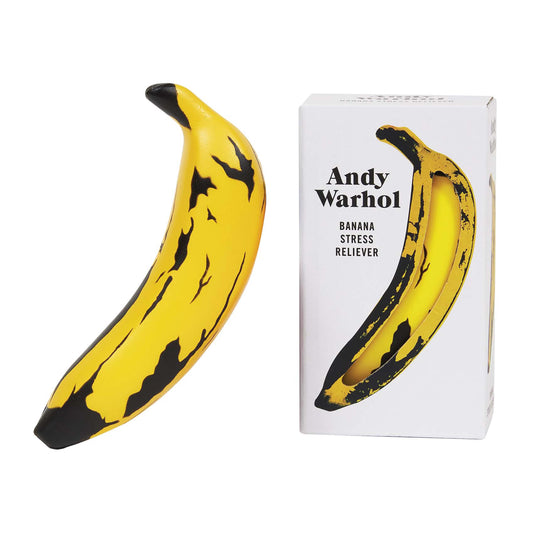 Yellow banana with black spots and matching stress reliever packaging on a white background