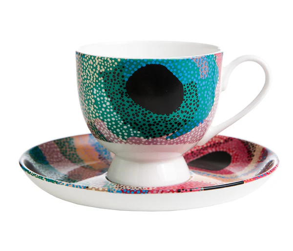 Tea cup and saucer set by Aboriginal artist , Marianne Burton with a white background.