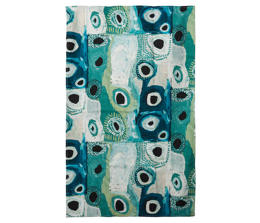 A  blue patterned Tea towel featuring  Australian indigenous art by May Wokka Chapman on a white background.