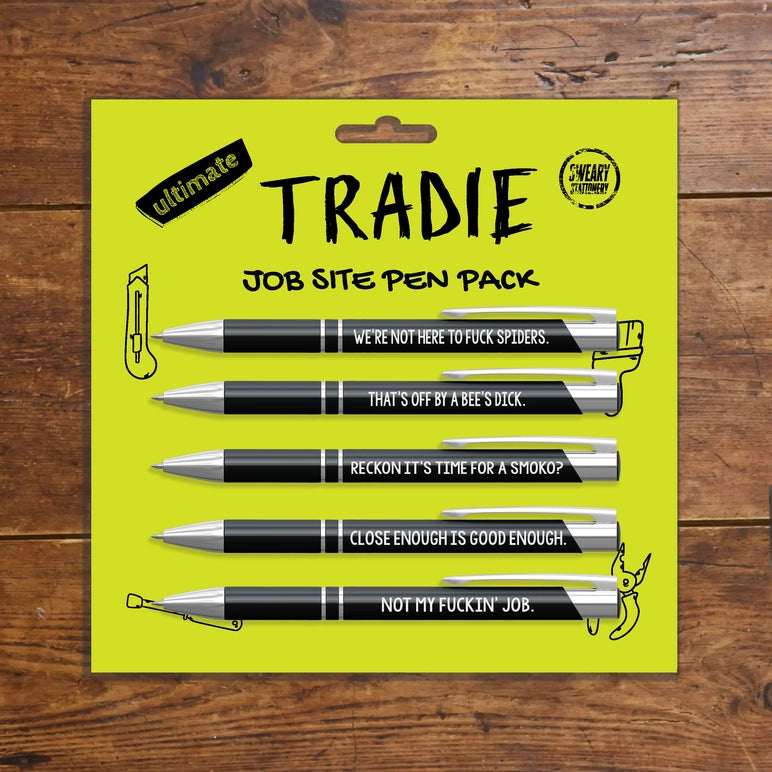 Job site pen pack with humorous sayings on a yellow card against a wooden background