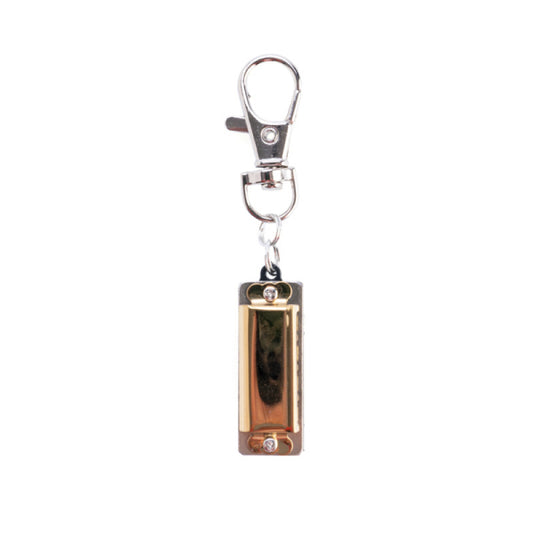 World's smallest harmonica with keyring on a white background