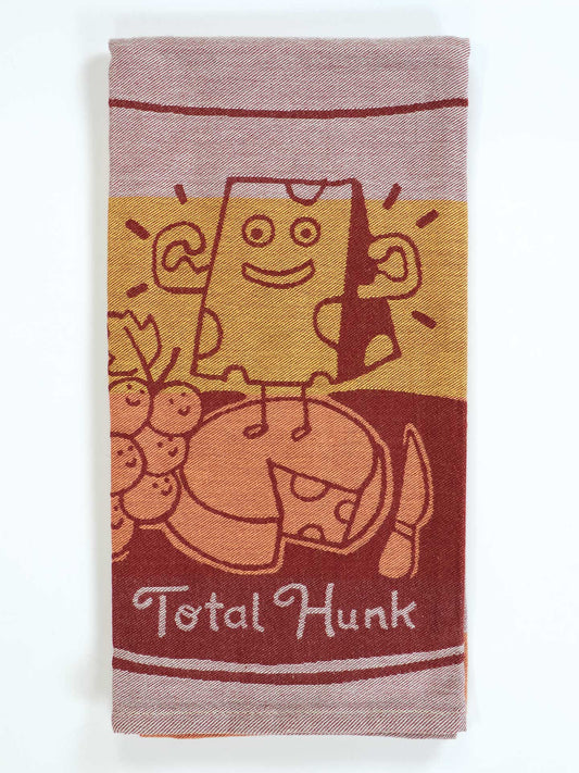 Towel with cartoon design of a box character on a horse, labeled 'Total Hunk', on a white background.