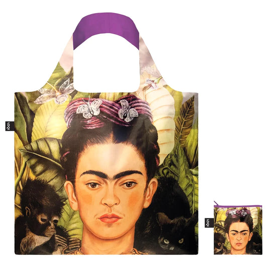 A shopping tote featuring Frida Kahlo artist and a smaller pouch with the same print to its right lower corner. The background is white.