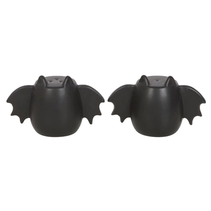 A set of two black bat winged salt and pepper shakers on a white background.