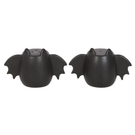 A set of two black bat winged salt and pepper shakers on a white background.
