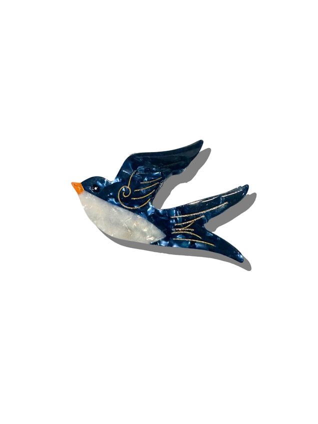 Decorative swallow-shaped blue hair claw on a white background