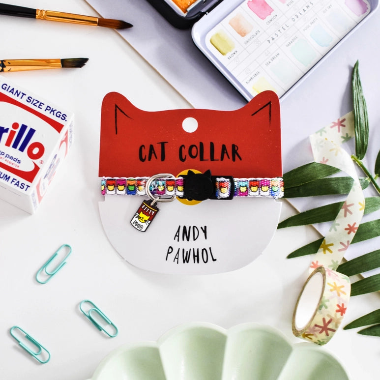 Cat collar with colorful design on a white surface with stationery items