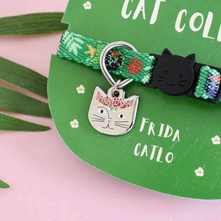 Cat collar with a decorative charm on a green card with 'Frida Catlo' branding.