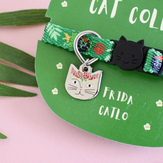 Cat collar with a decorative charm on a green card with 'Frida Catlo' branding.