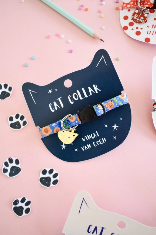 Cat collar with colorful design on a black cat-shaped card with 'Cat Collar' text, on a pink background with paw prints.