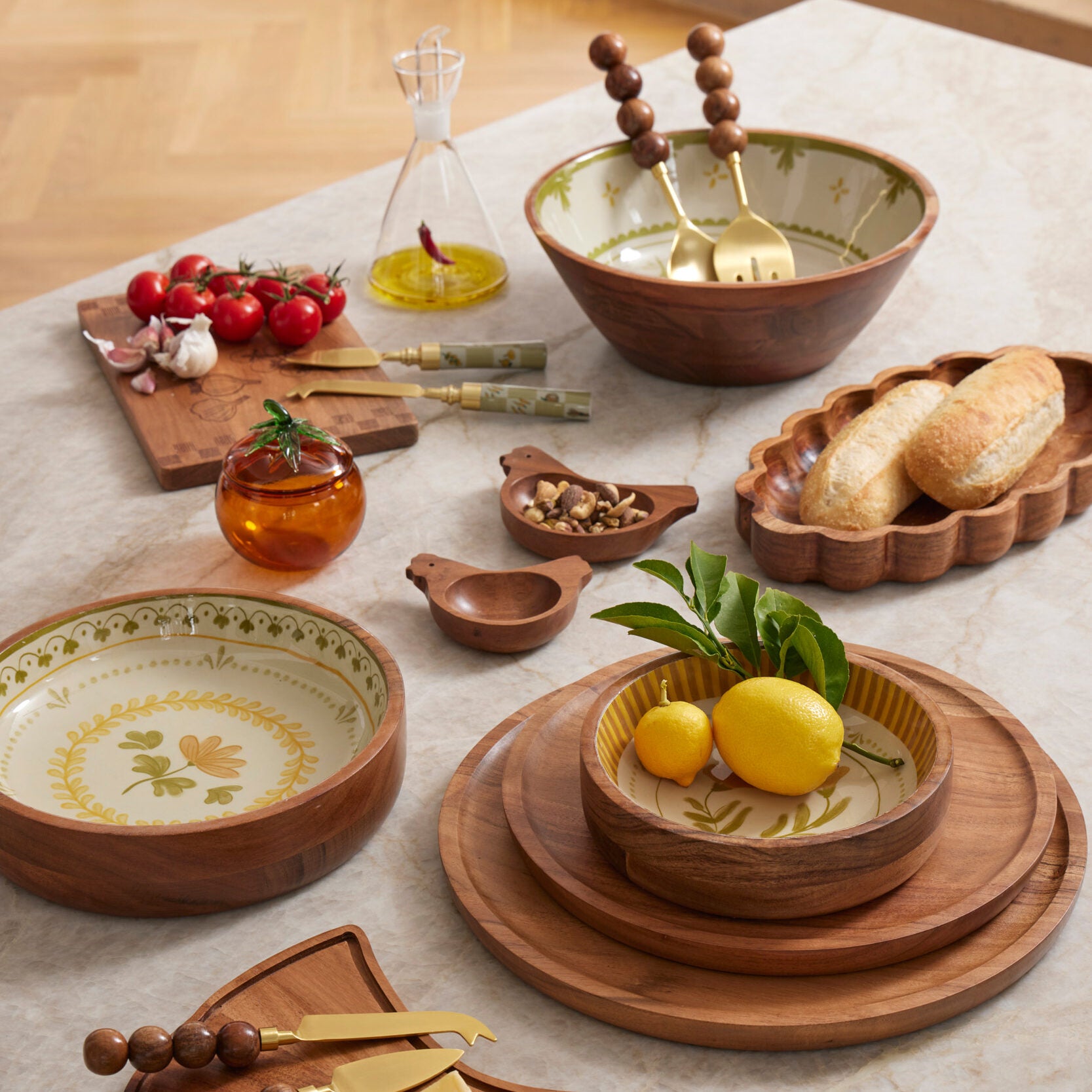 Wooden and ceramic tableware set on a light surface with lemons and bread.
