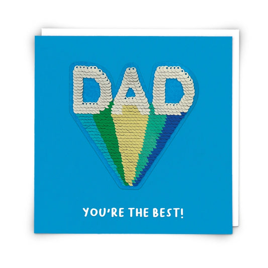 A blue greeting card featuring a sequined removable patch with text: Dad, you're the best on a white ackground.