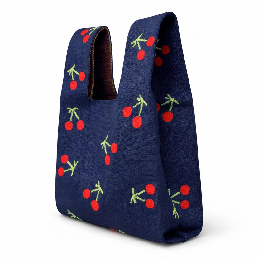 Navy blue bag with cherry pattern on a white background