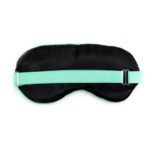 A back view of a  black sleep mask with a green strap on a white background.