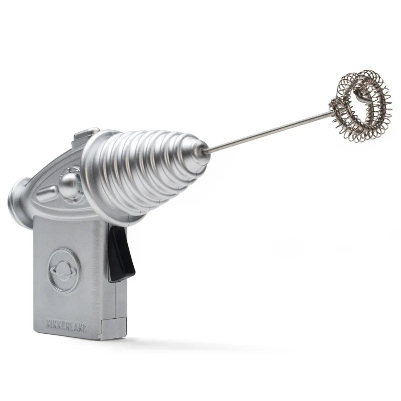 A kitchen gadget milk frother shaped like a space gun on a white background.
