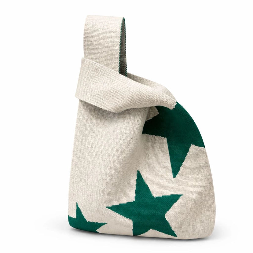Beige bag with green star patterns on a white background