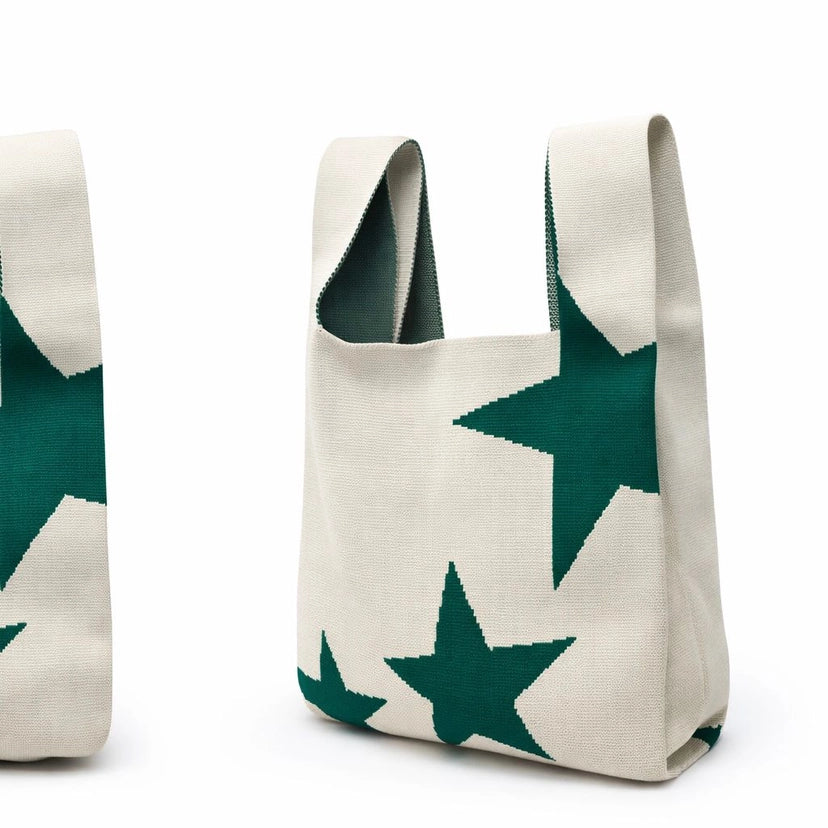 Tote bag with green star patterns on a white background