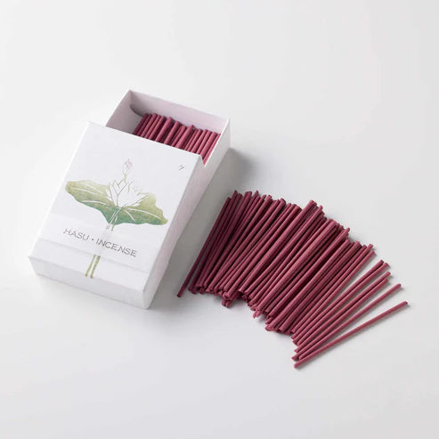 Maroon incense sticks with a white box labeled 'HASU INCENSE' on a light gray background