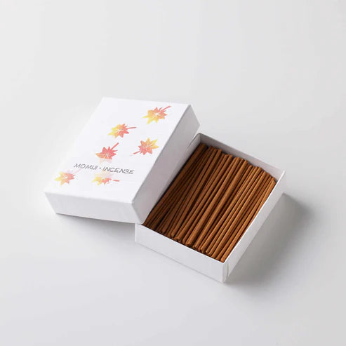 Incense sticks in a white box with colorful designs on a light gray background