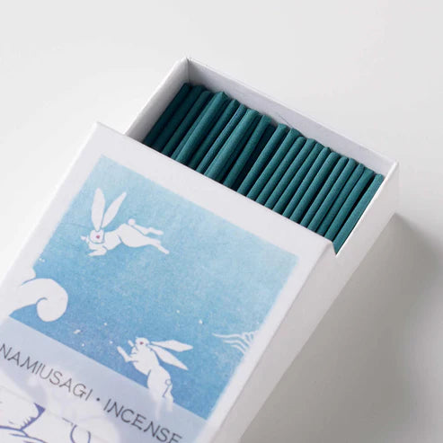 Incense sticks in a box with a blue design and white text on a light gray background