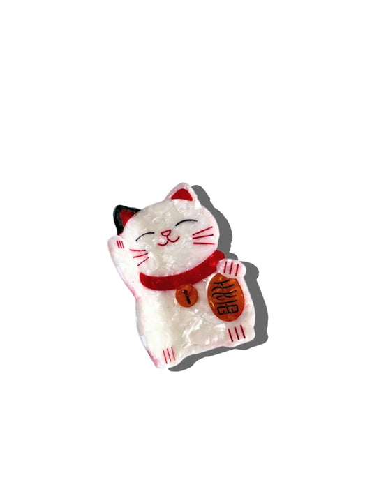 Maneki-neko cat hair claw with a red scarf on a white background