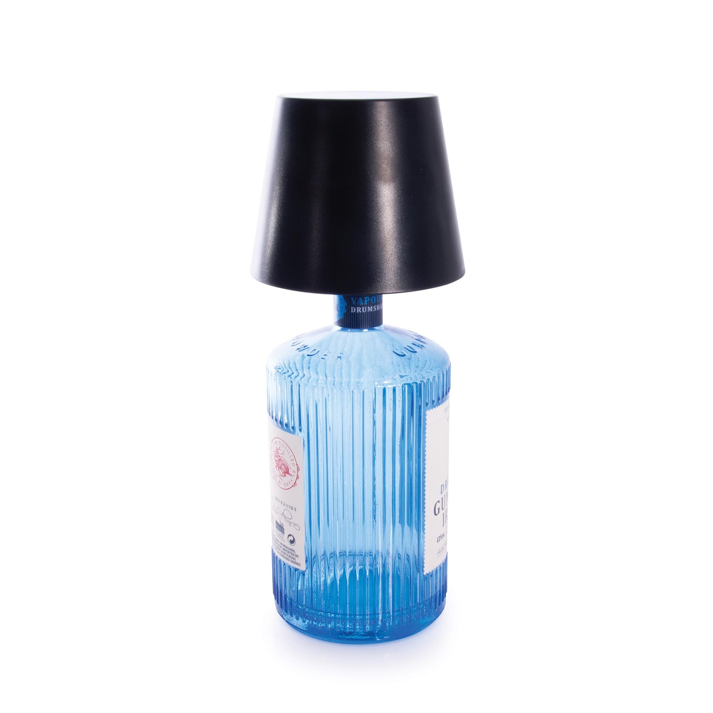 Rechargeable Bottle top lamp, placed upon a blue Gin bottle. White background.