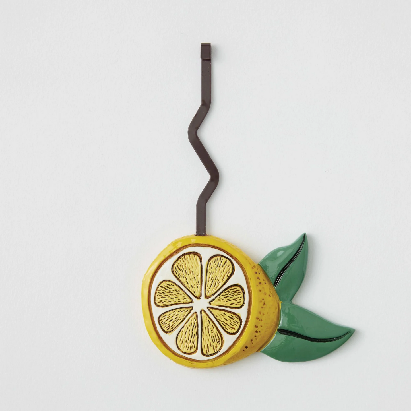 Pendulum piece Decorative lemon slice with a leaf on a white background
