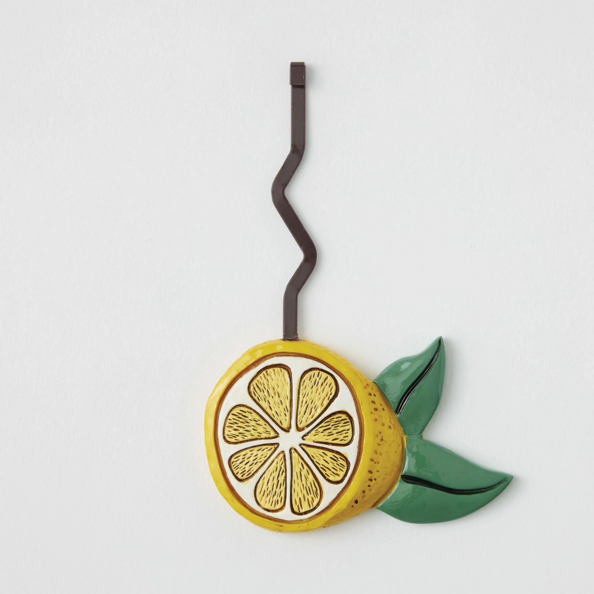 Pendulum piece Decorative lemon slice with a leaf on a white background