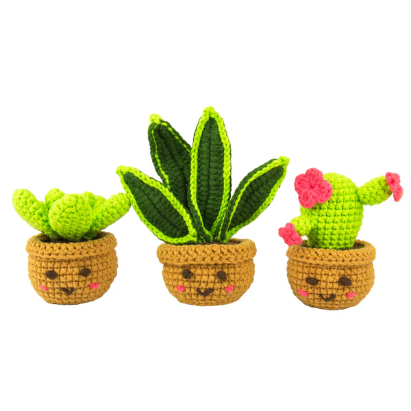 Three crocheted cactus plants with pot faces on a white background