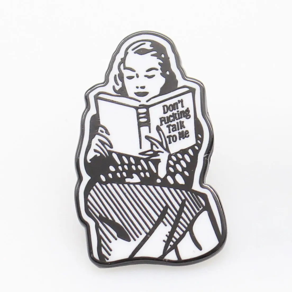 Enamel pin with a design of a person reading a book titled 'Don't Fucking Talk to Me' on a white background.