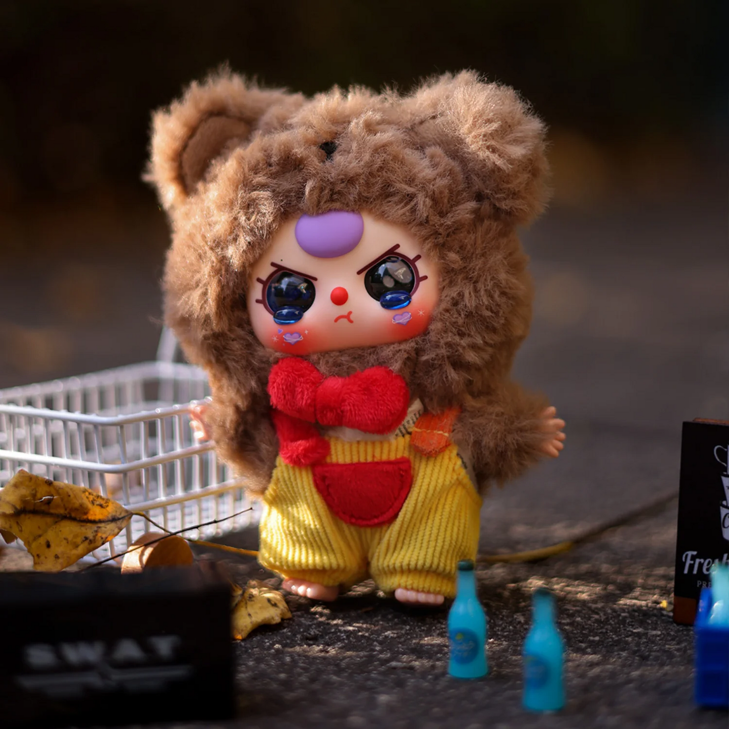 Toy figure of a character in a bear costume with a sad expression on a dark background