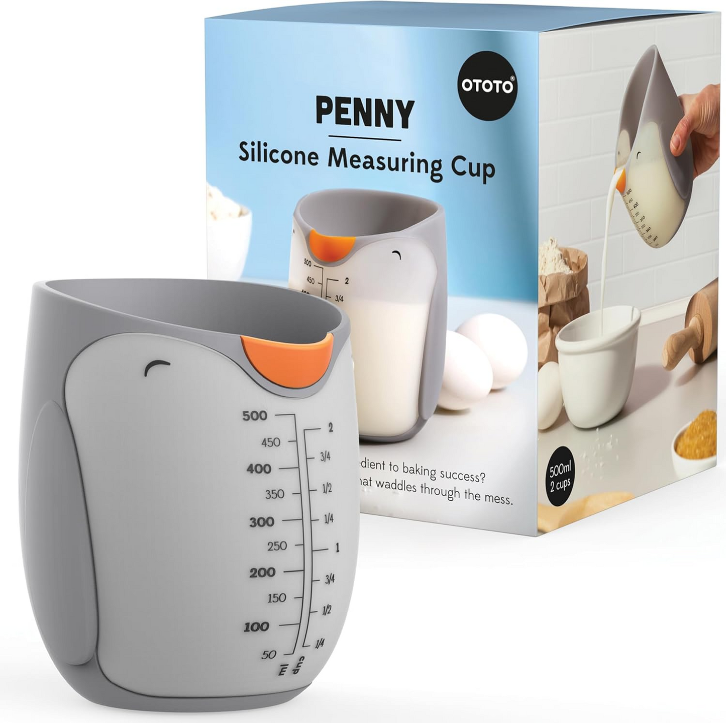 Penguin shaped silicone measuring cup with blue packaging box on a white background.