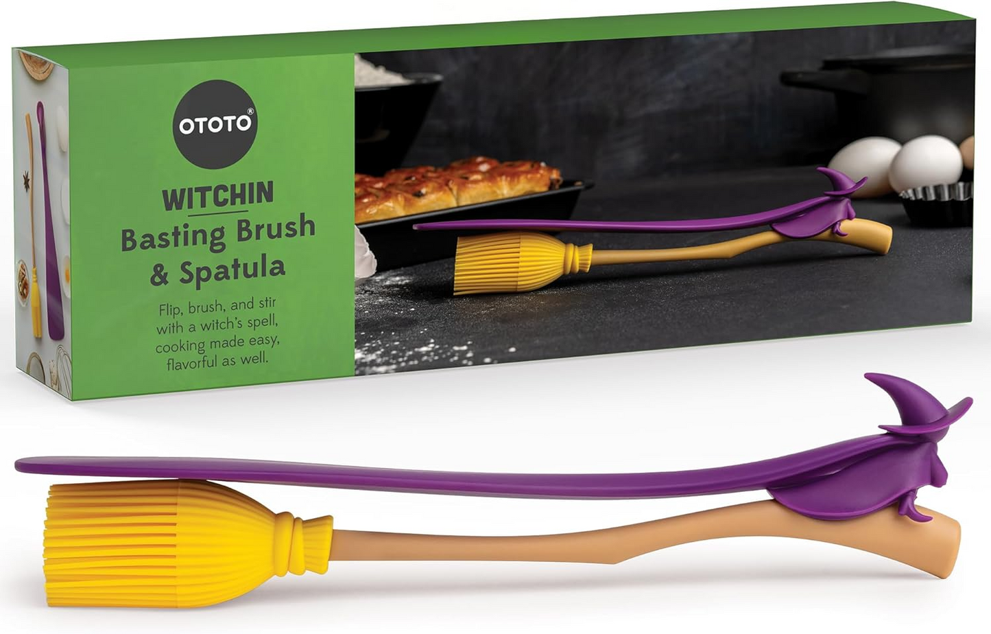 A pastry brush and purple witch spatula with a green packaging box in the background.
